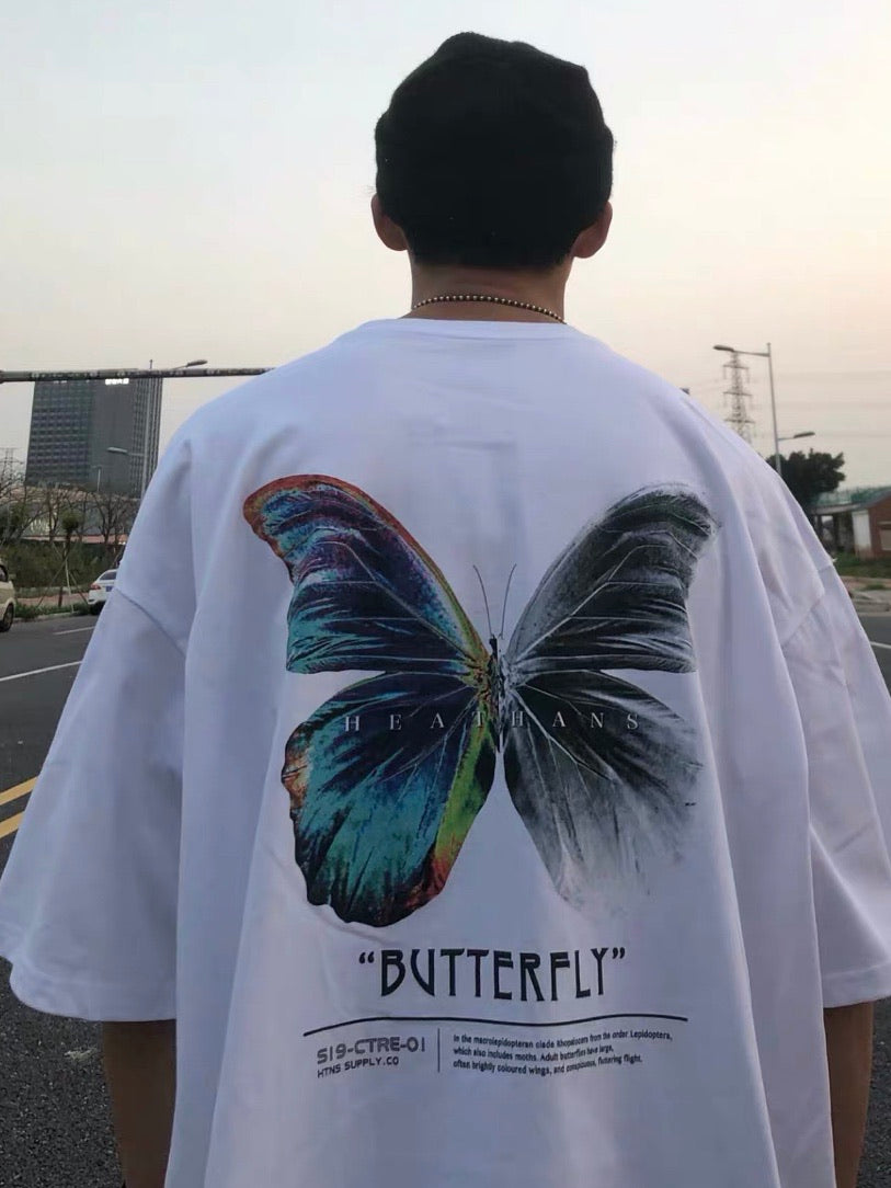 back view, white tshirt with a big butterly printed. One side is multicolor and the other in black and white worn