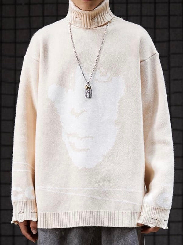 beige knitted sweater with a white face on the front and a barbed wire