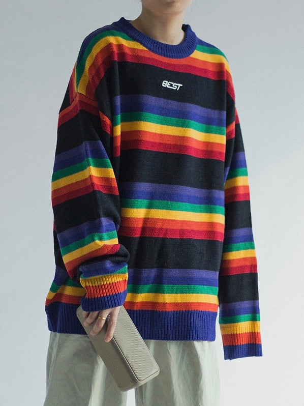 knitted sweater with rainbow lines between big black lines. Best is embroidered in white on the chest on a black line