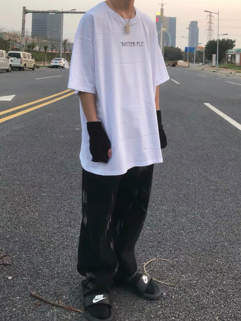 front side, white loose tshirt with butterfly written on the top, worn