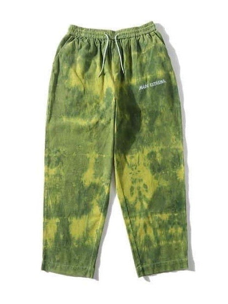 green tie and dye velvet long pants vh studios with made extreme embroidered in white on the top of the left thigh. t has an elastic waist adjustable with a white lace