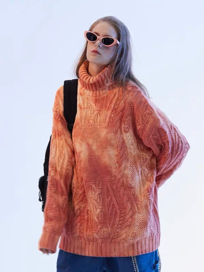 orange tie and dye knitted polyester sweater with a turtle neck worn