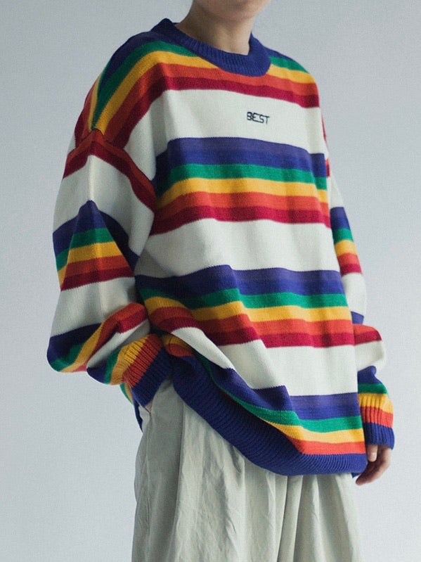 knitted sweater with rainbow lines between big white lines. Best is embroidered in black on the chest on a white line