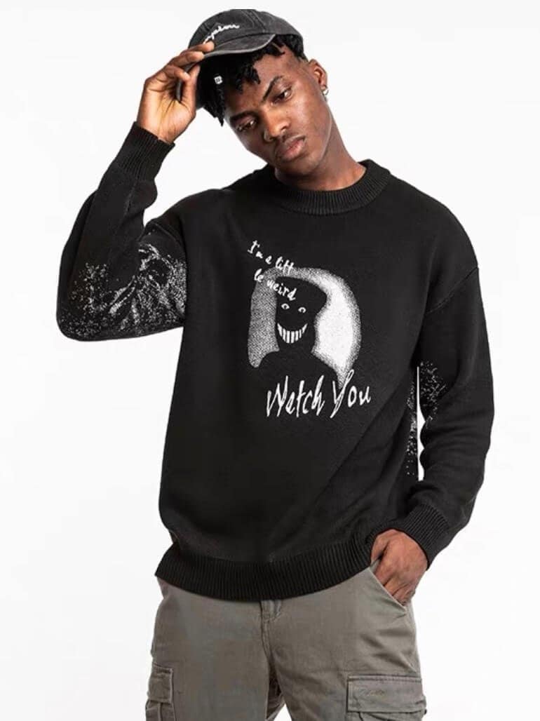 black sweater with a creepy smiling silhouette shadow printed with the text watch you front view