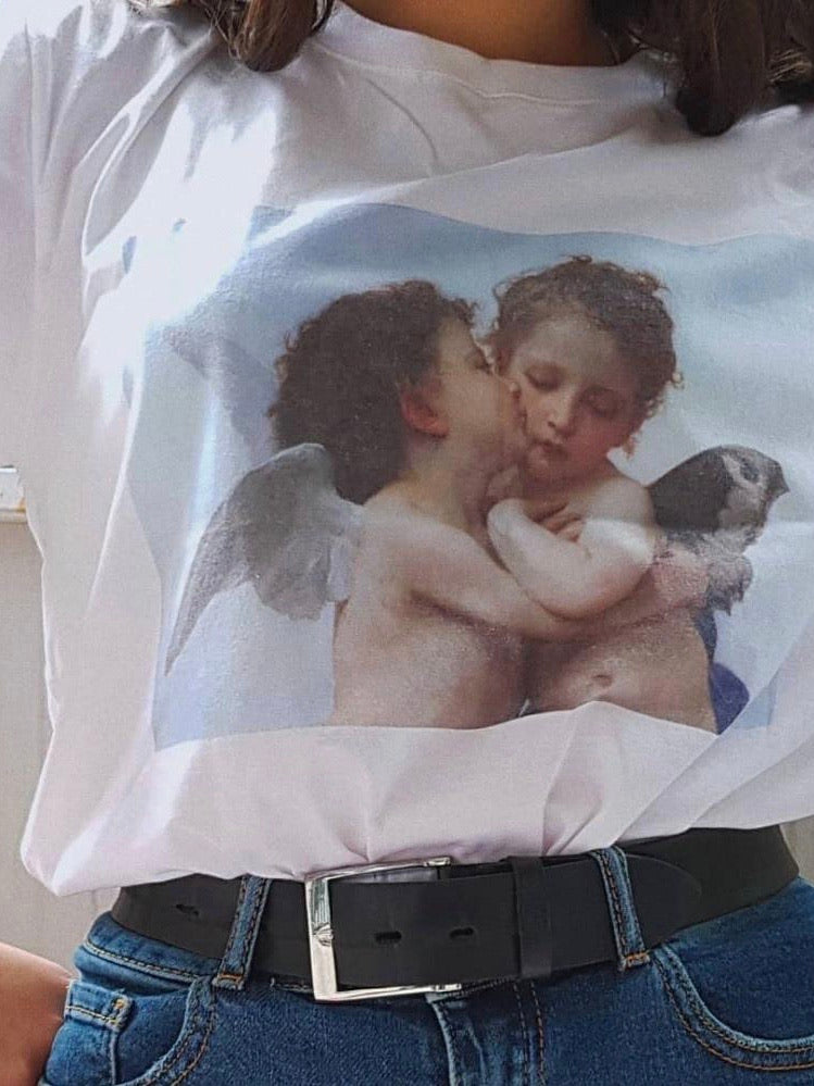 zoom of the white tshirt with a print of two angels, one kissing the other on the cheek