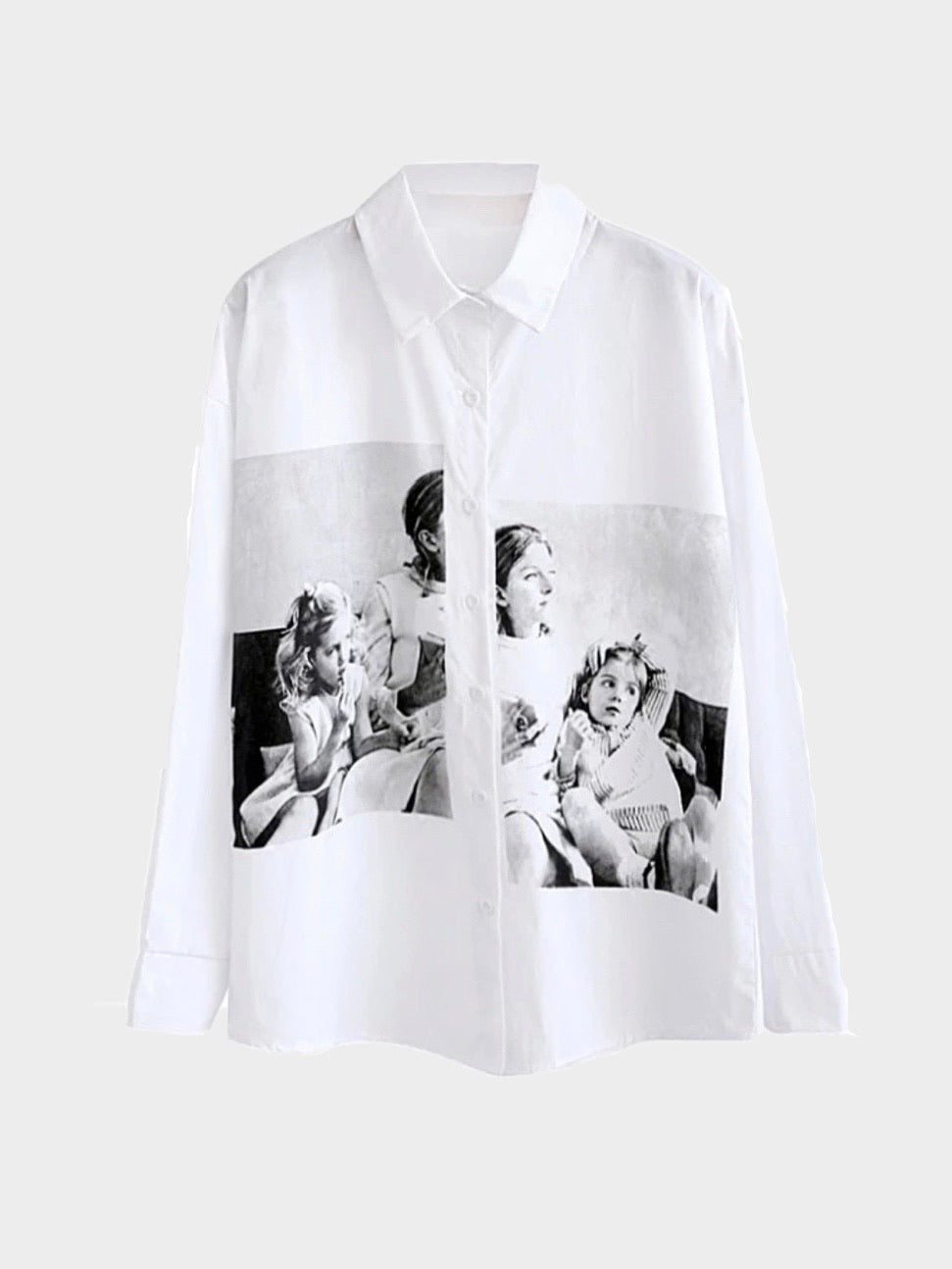 white shirt with a big picture printed in black and white split by the buttons that close the shirt of three girls