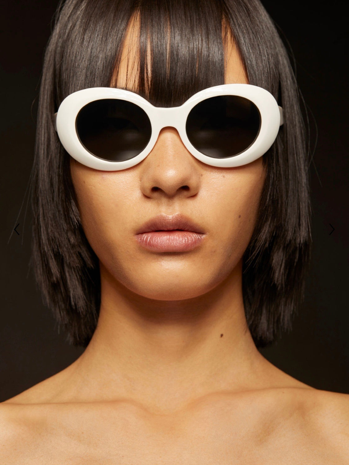 white frame and black glass sunglasses worn by a woman