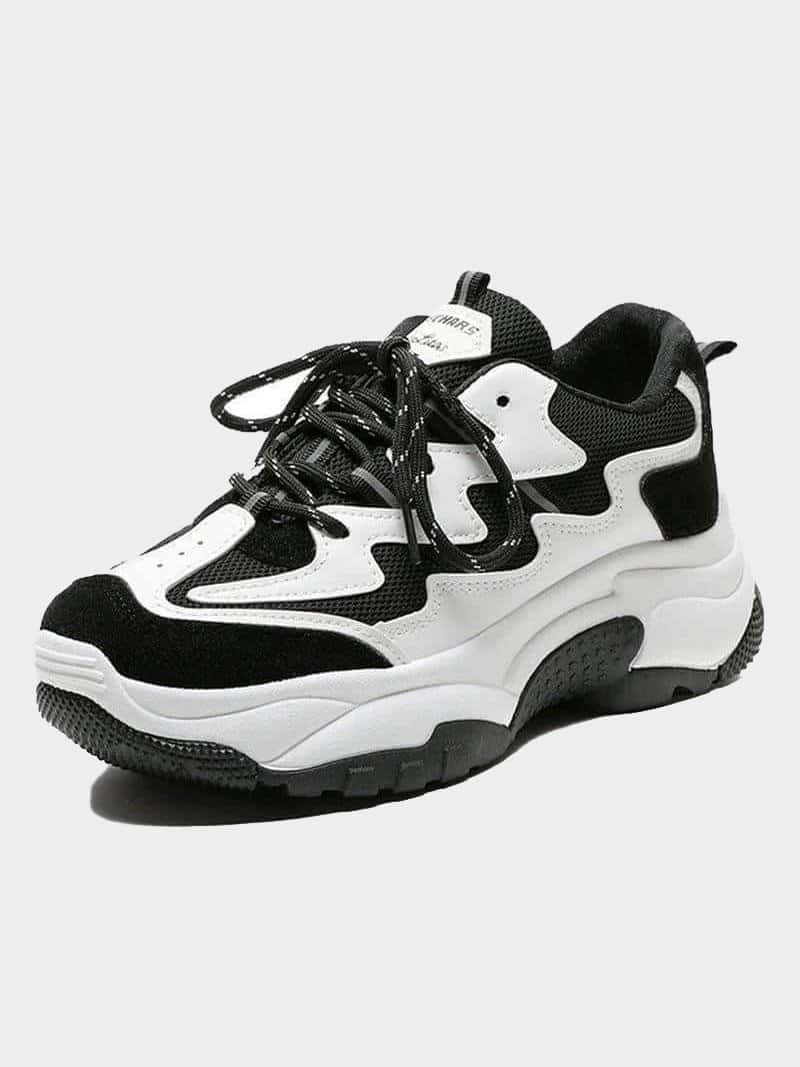 black and white sport shoe sneakers with black round laces