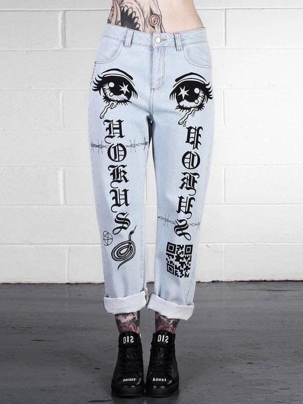 light blue jeans with two eyes at the top of the thighs, with gothic letters on the legs and snake, pentagram and qr code symbols in black