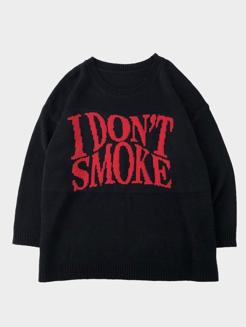 black knitter sweater with I don't smoke written in big red letters on the chest