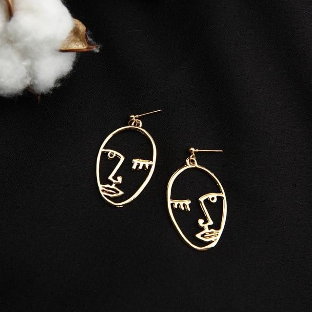 Gold Eyes Closed Face earrings