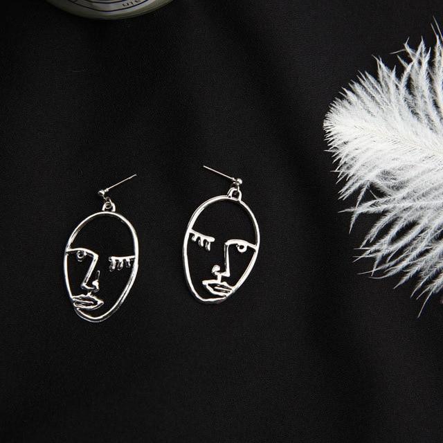 silver Eyes Closed Face earrings