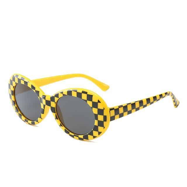 checkered black and yellow frame and black glass sunglasses